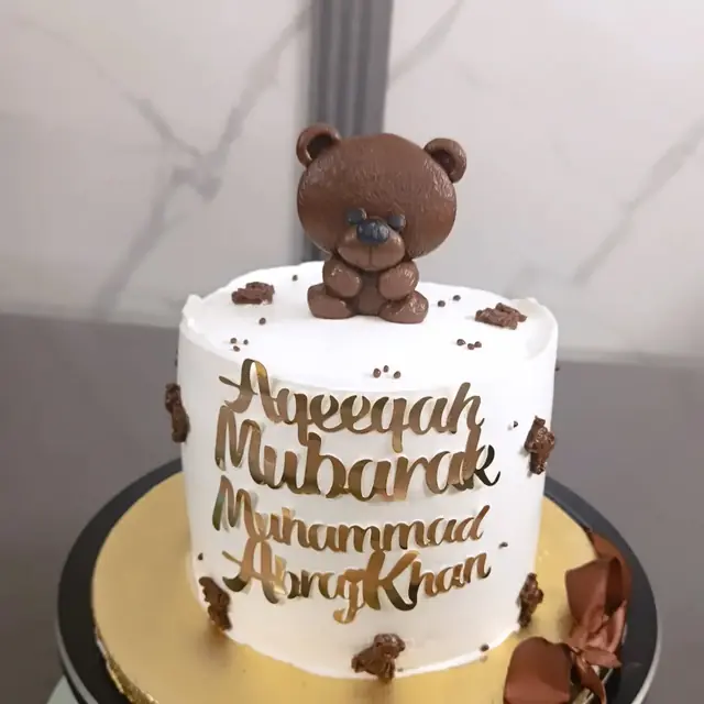 Aqeeqah Mubarak: Teddy on top, gold script